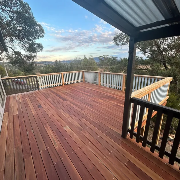 Roofed outdoor area with a hardwood deck and valley outlook