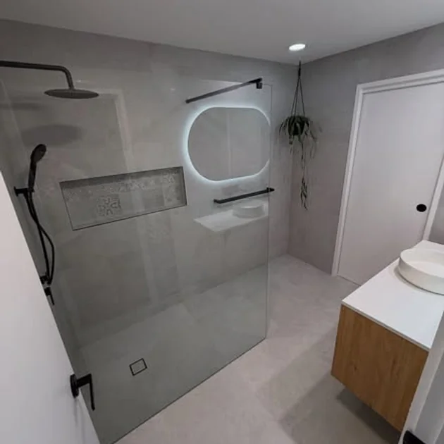 Renovated bathroom with a walk-in shower and timber vanity