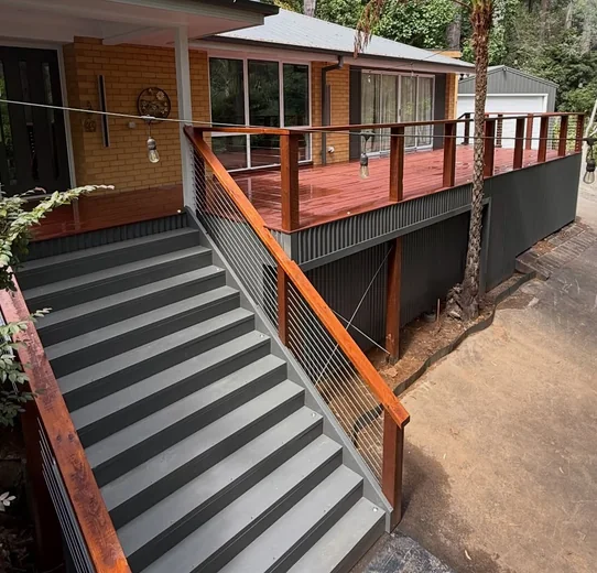 Elevated deck and external stairs at a treed property