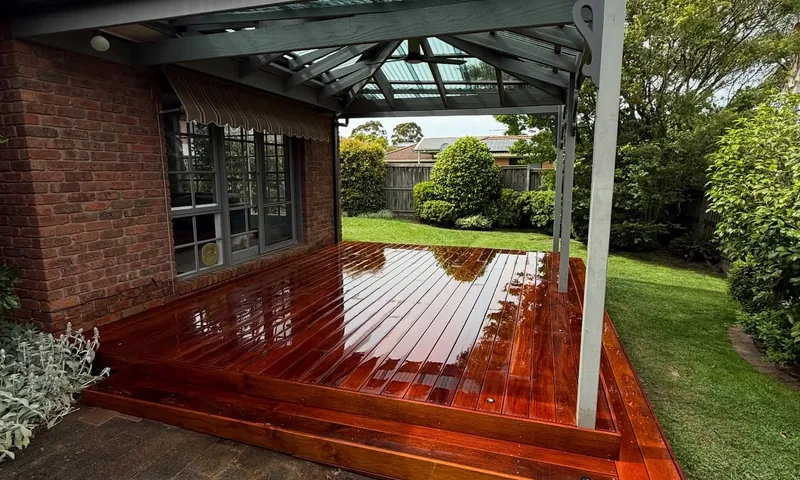 Hardwood deck under a glass verandah roof