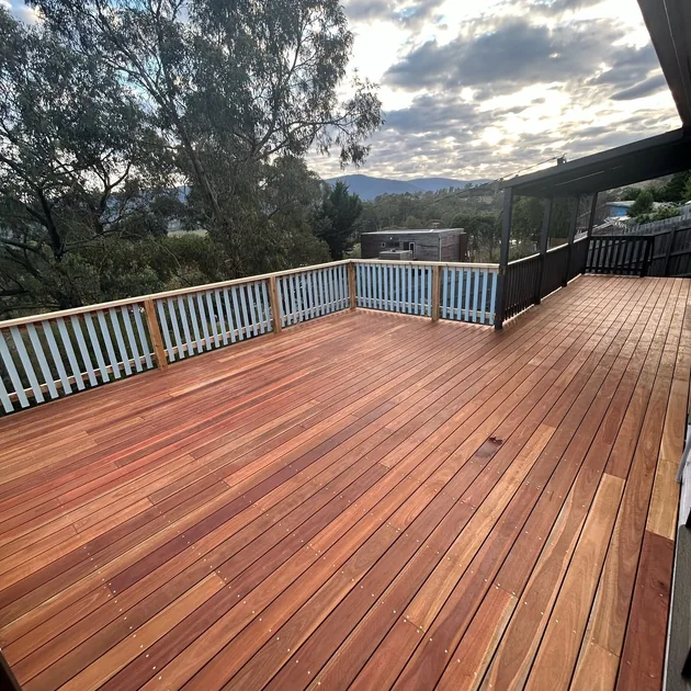 Hardwood deck with a painted balustrade and a valley outlook
