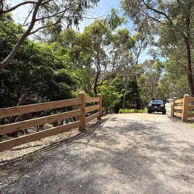 Post and rail fence with a timber gate