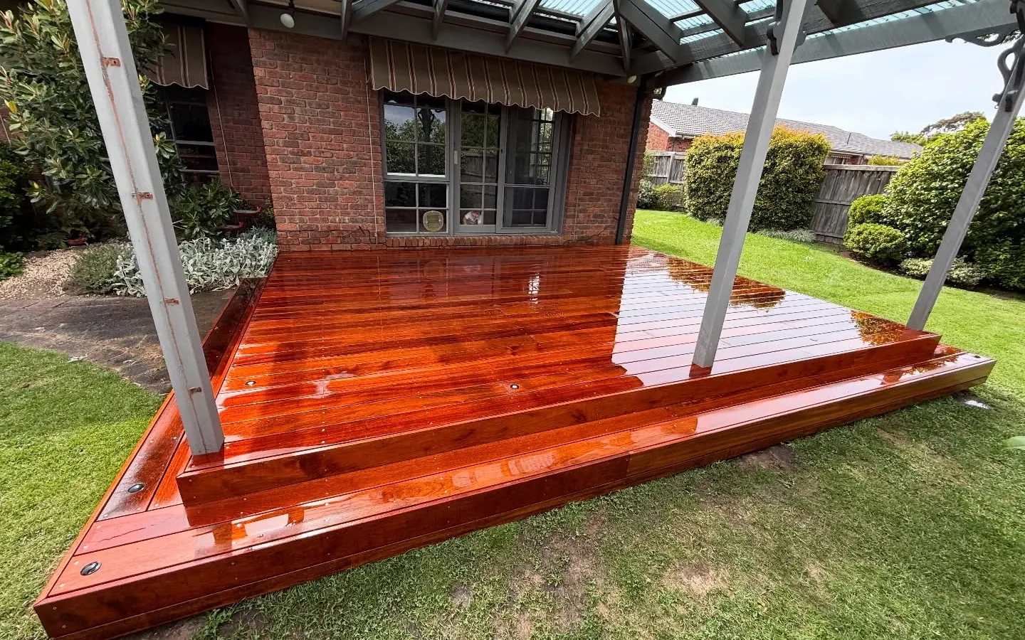 Hardwood deck under a glass verandah roof