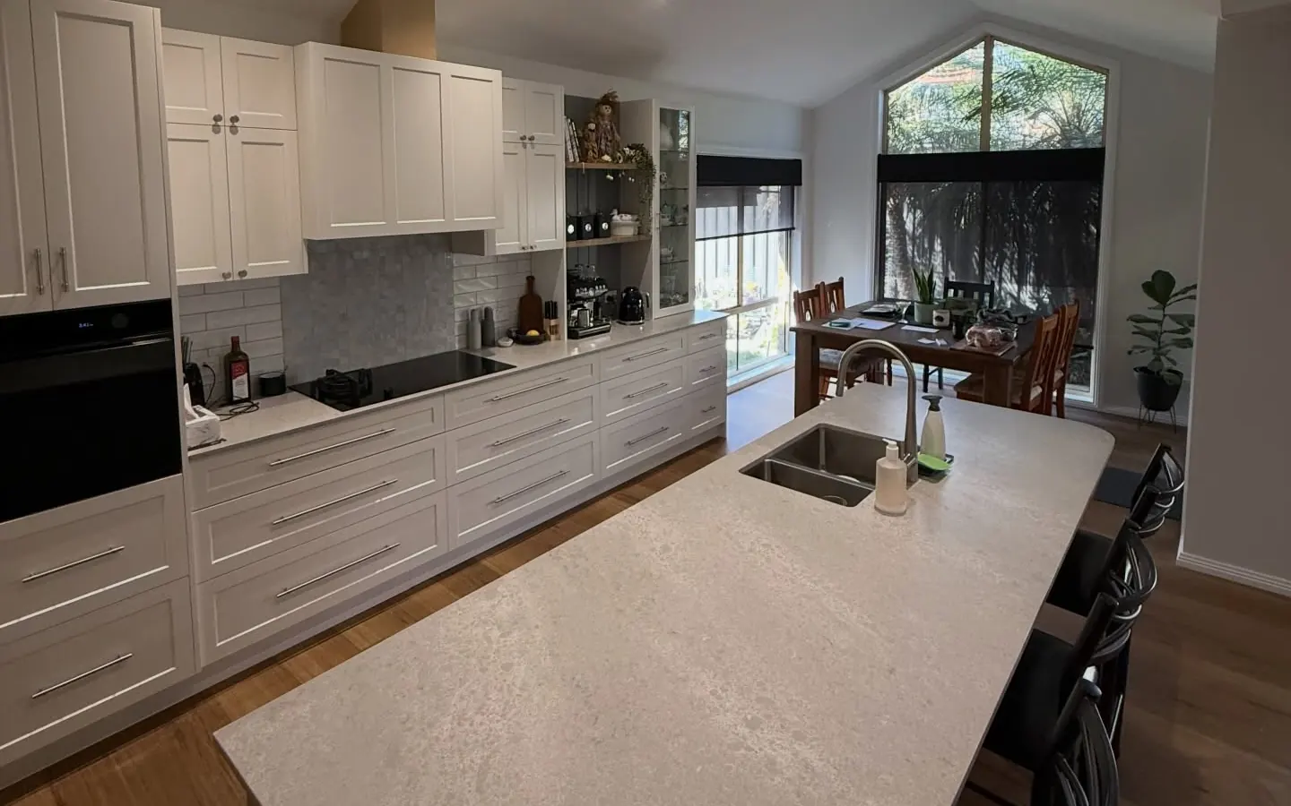 Open plan kitchen and dining area under a raked ceiling