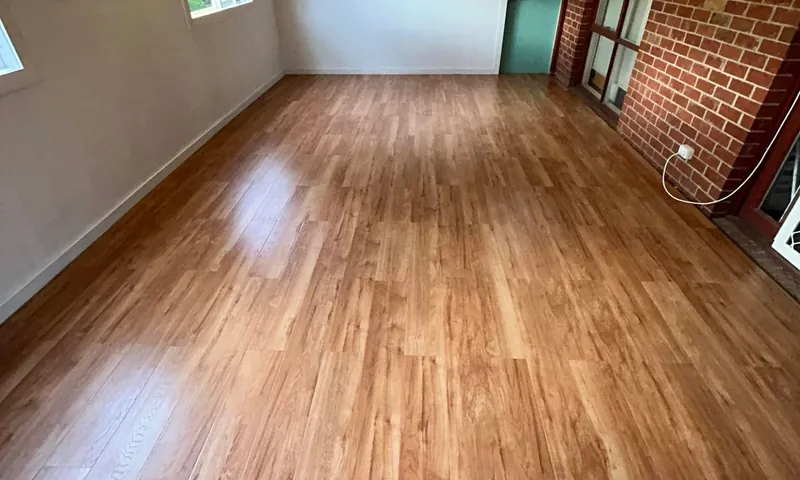 New room finished with timber flooring and a brick feature wall