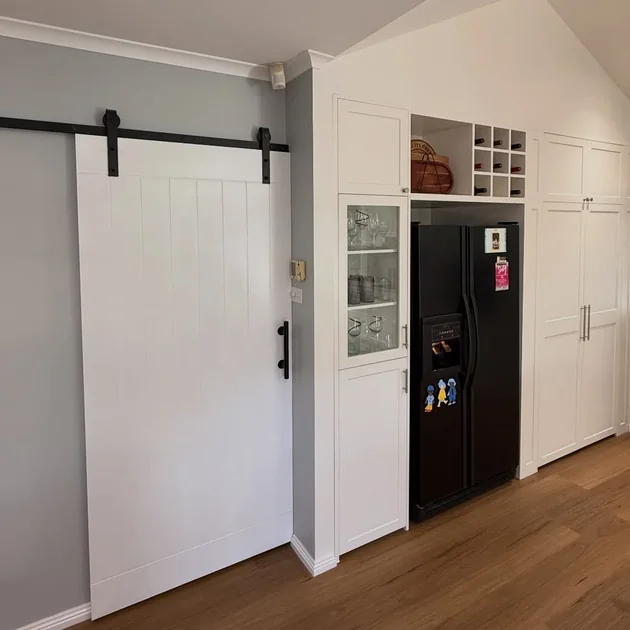 Barn door and cabinetry in a renovated hallway