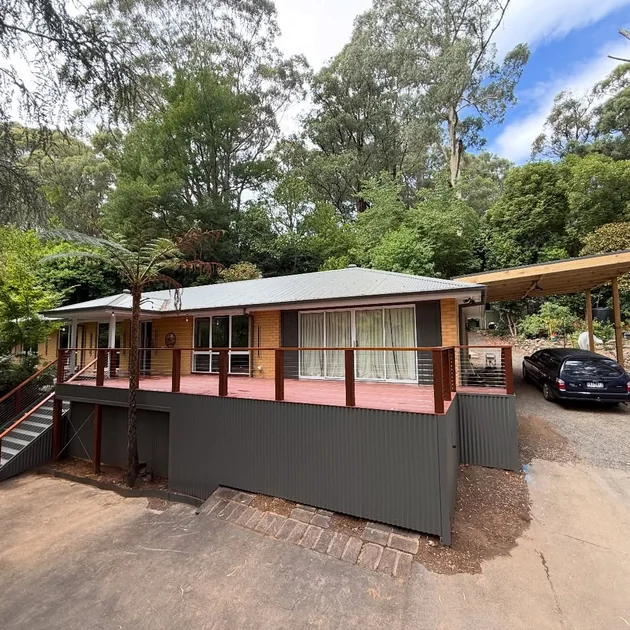 Exterior of a clad home with an elevated deck across the front