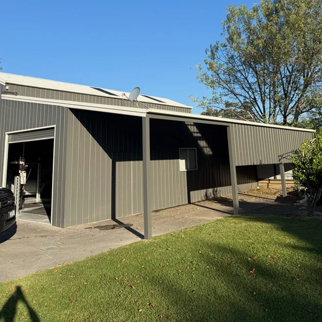 Large steel shed and garage with an open bay