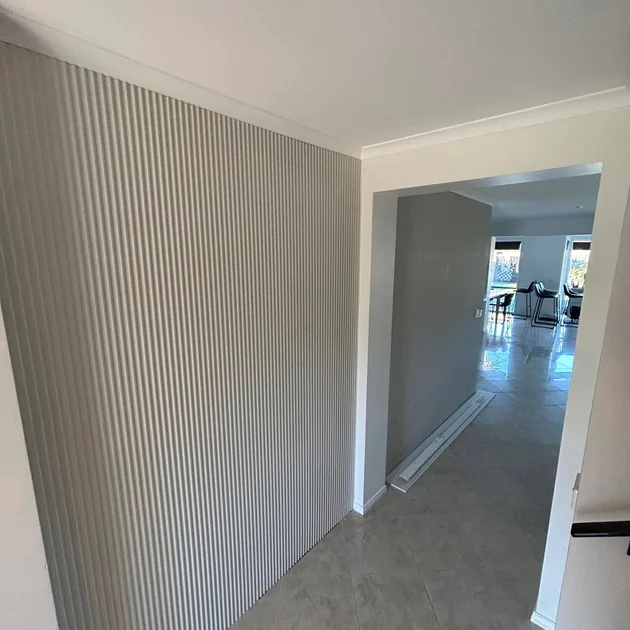 Hallway lined with white vertical joint panelling