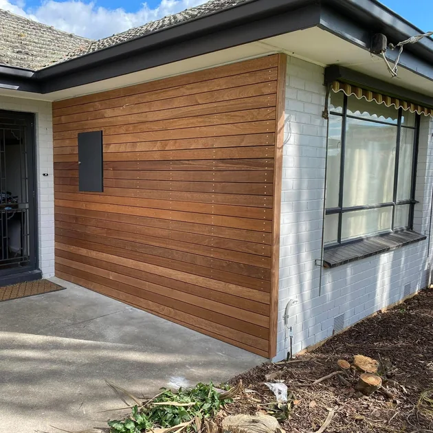 Detail of horizontal timber cladding on a rendered wall