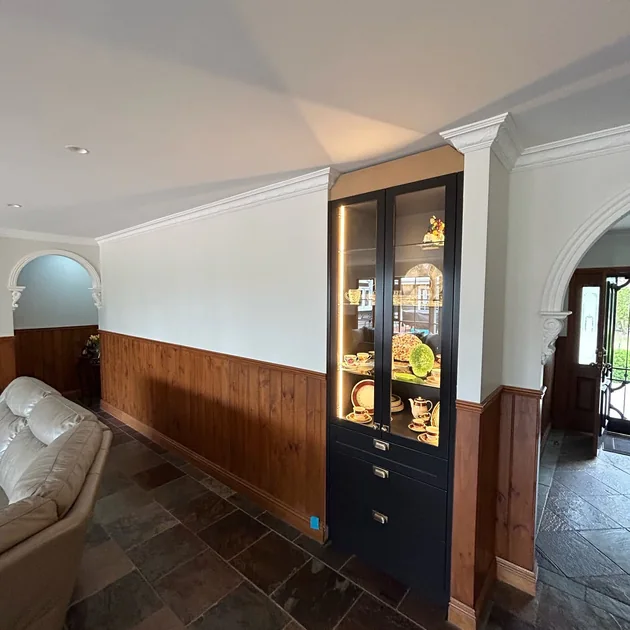 Renovated interior with timber wainscoting and built-in cabinetry