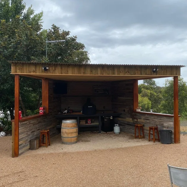 Custom outdoor bar built from recycled timber under a corrugated roof