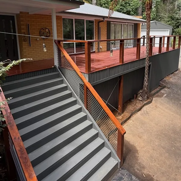 Elevated merbau deck with a cable balustrade and wide entry stairs