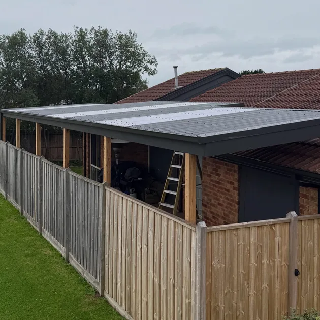 Flat roof verandah with timber posts running along a brick home